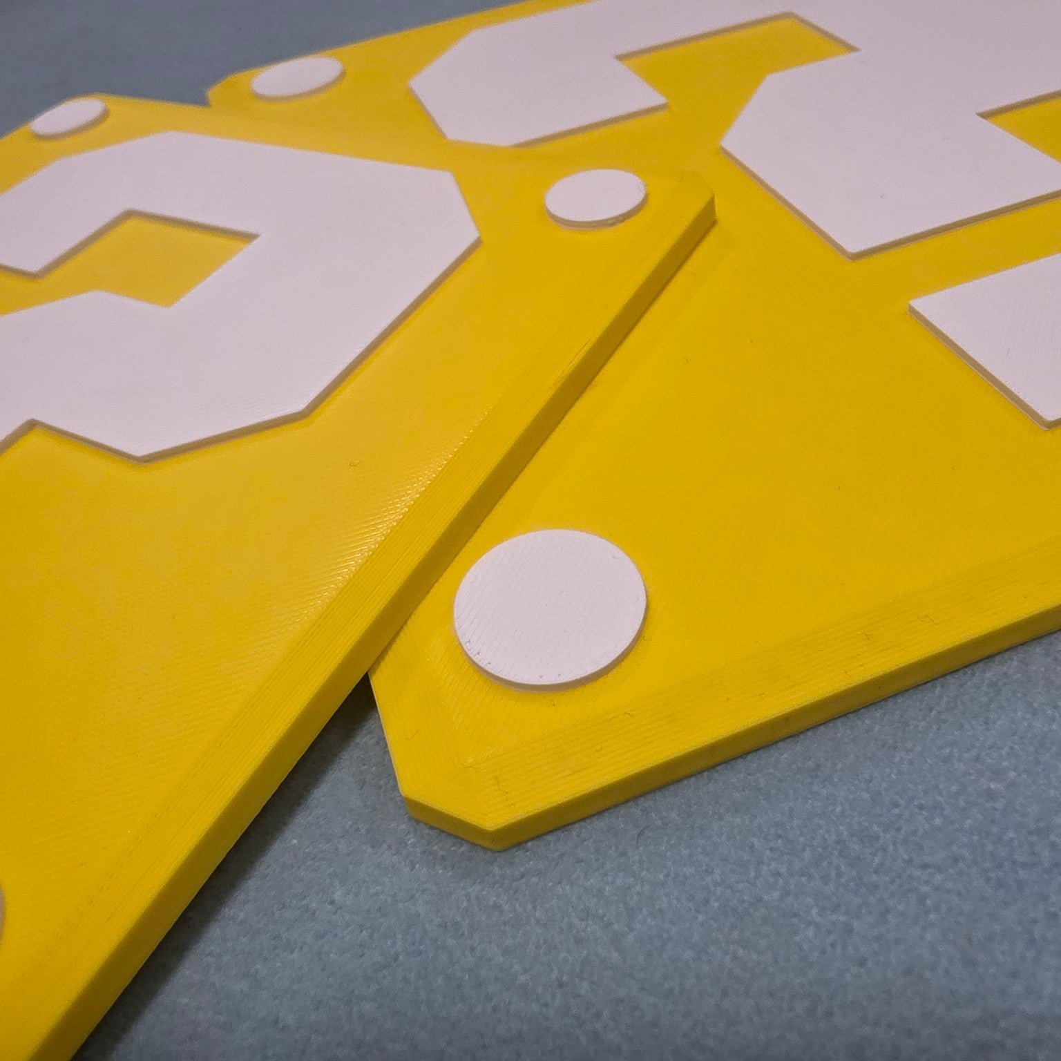 Close-up of yellow and white question block inspired 3D printed sign