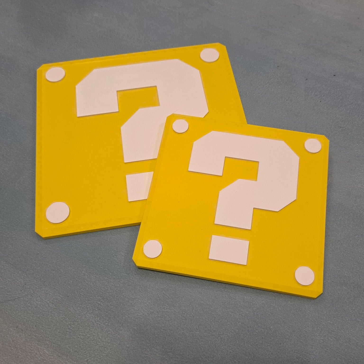 Two sizes of yellow question block inspired 3D printed sign