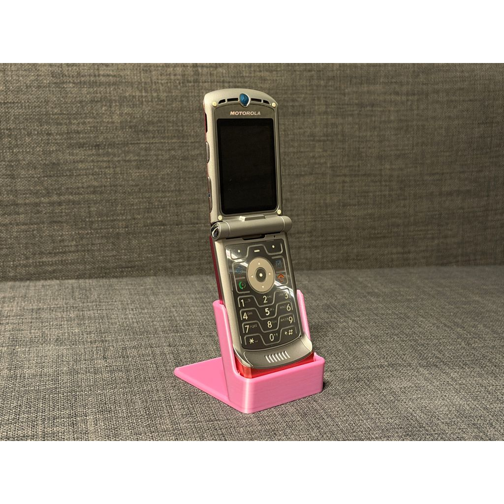 Motorola RAZR V3 displayed open in a pink 3D printed stand