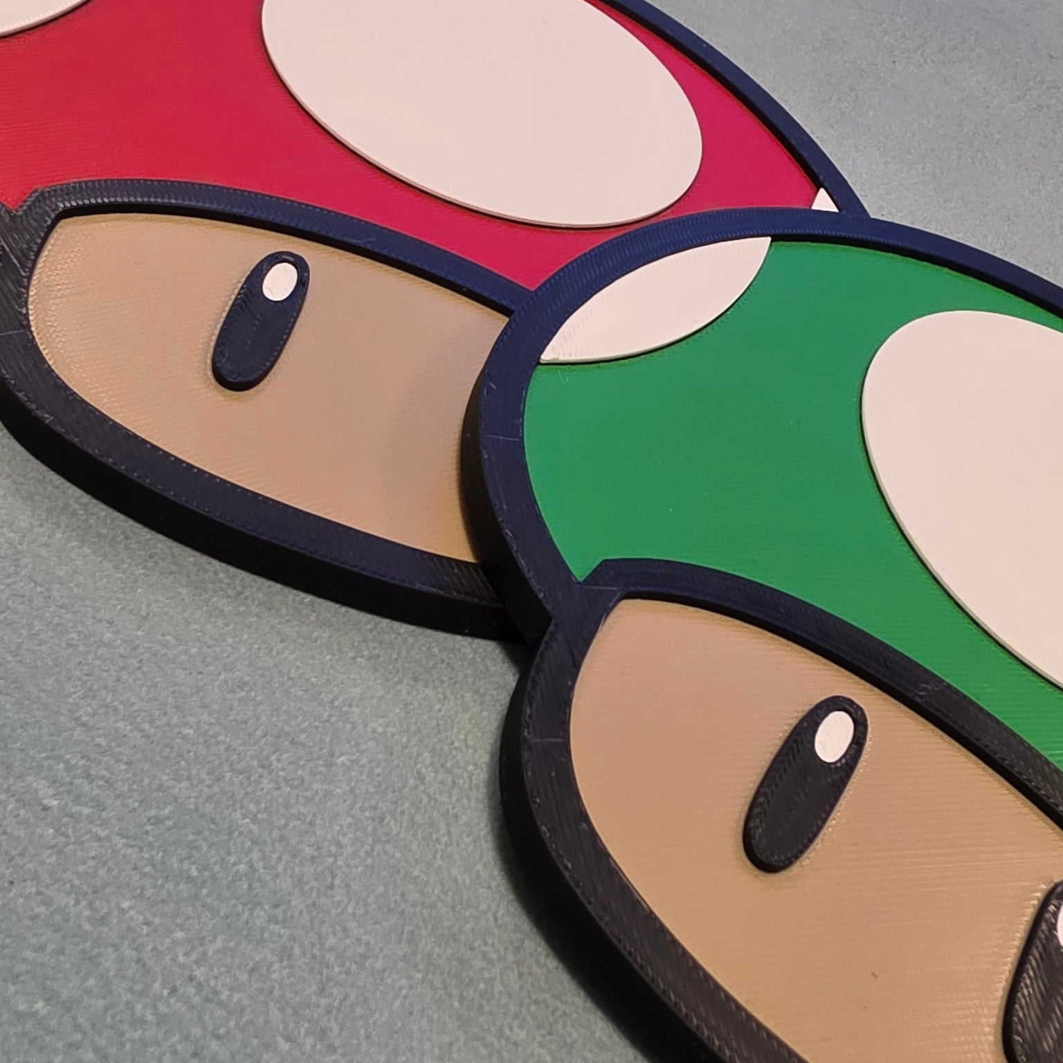 Close up detail of red and green mushroom inspired 3D printed wall decor