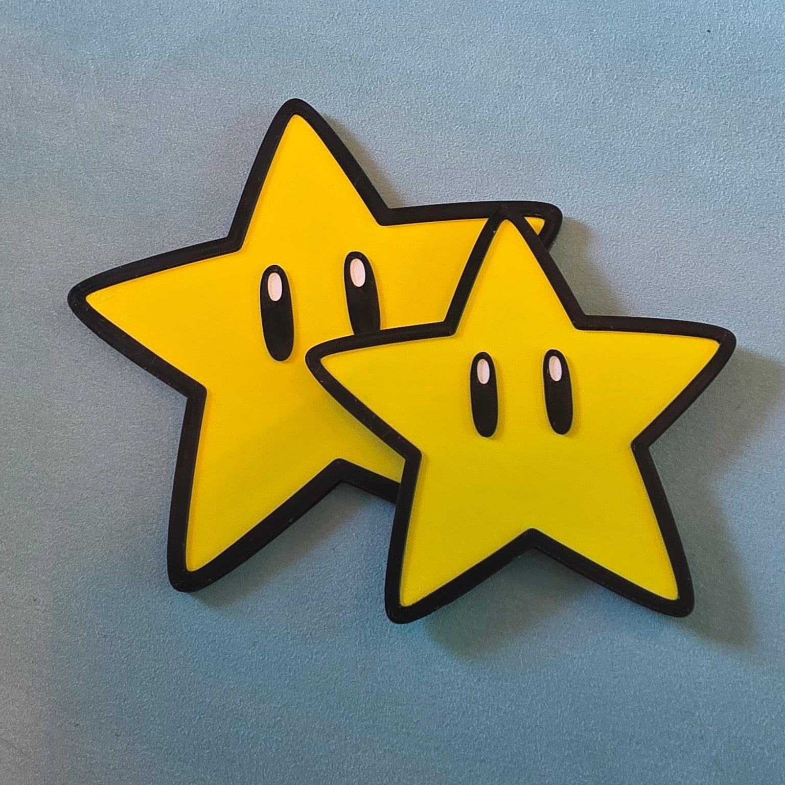 Small and large Super Mario star inspired 3D printed gaming signs