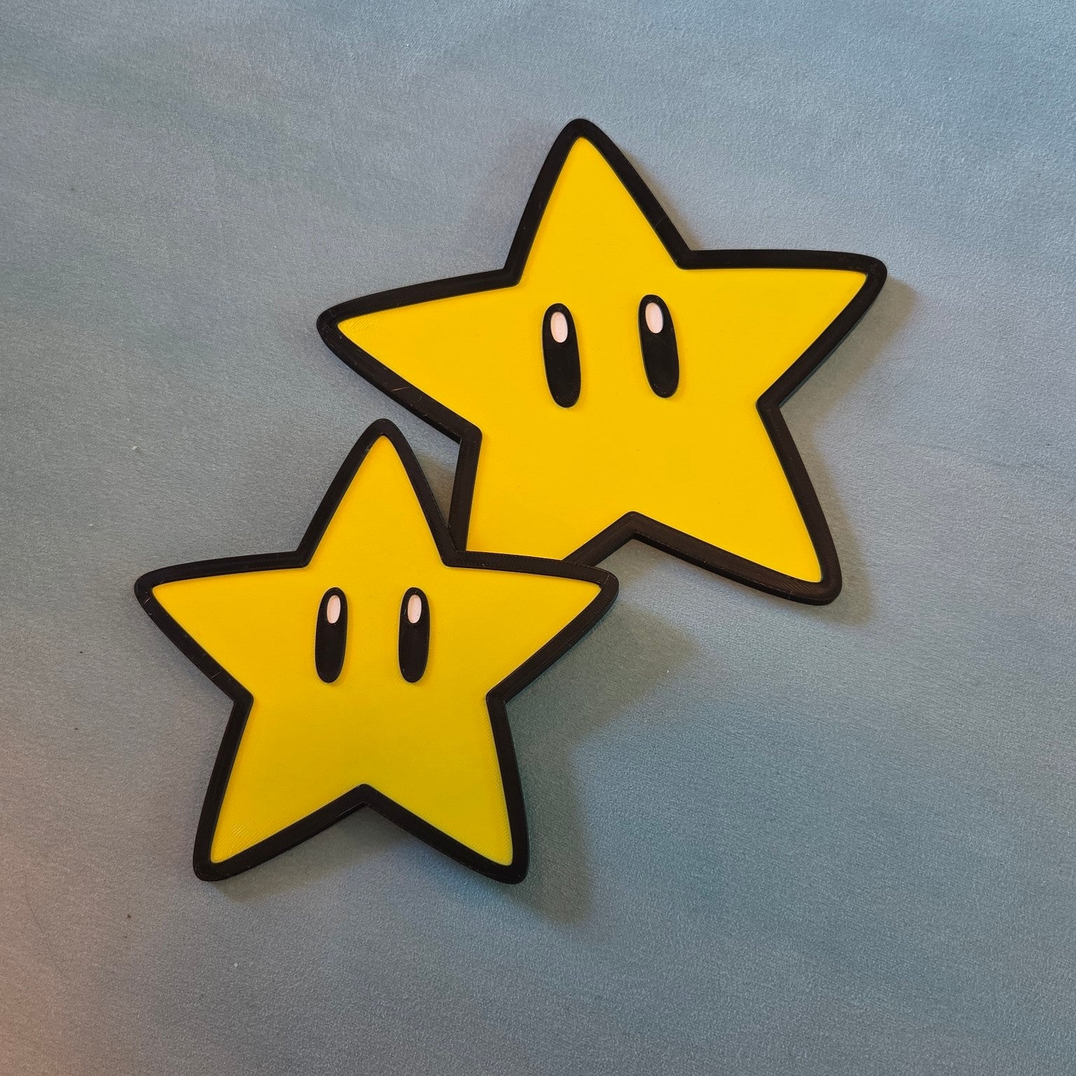 Small and large yellow Super Mario star inspired 3D printed signs